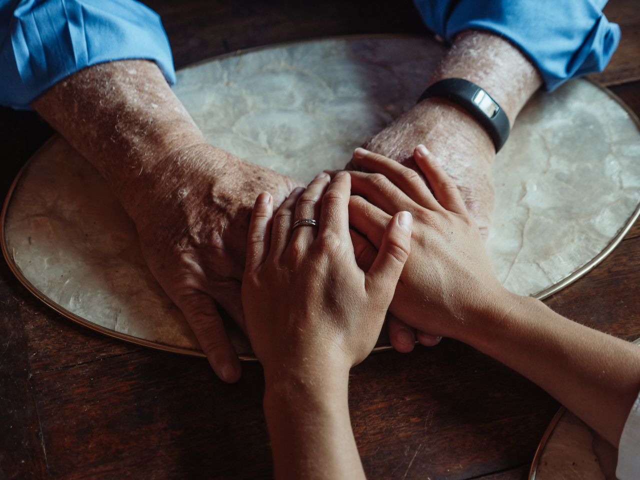 Home Close-up of elderly and young hands joined, symbolizing compassion and support.